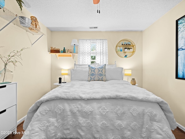 433 Dion Dr, Hubert, NC 28539 - bedroom with visible vents, a textured ceiling, baseboards, and dark wood-style floors