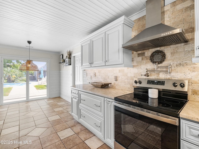 433 Dion Dr, Hubert, NC 28539 - kitchen with stainless steel electric range, wall chimney range hood, light countertops, white cabinets, and decorative backsplash