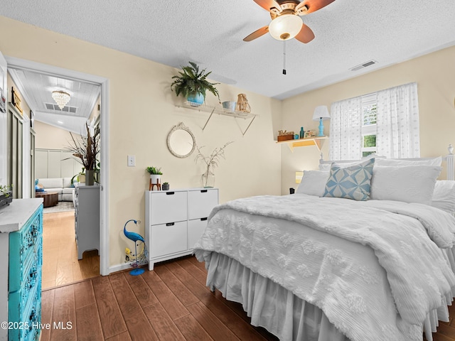 433 Dion Dr, Hubert, NC 28539 - bedroom featuring dark wood-type flooring, a textured ceiling, baseboards, and ceiling fan