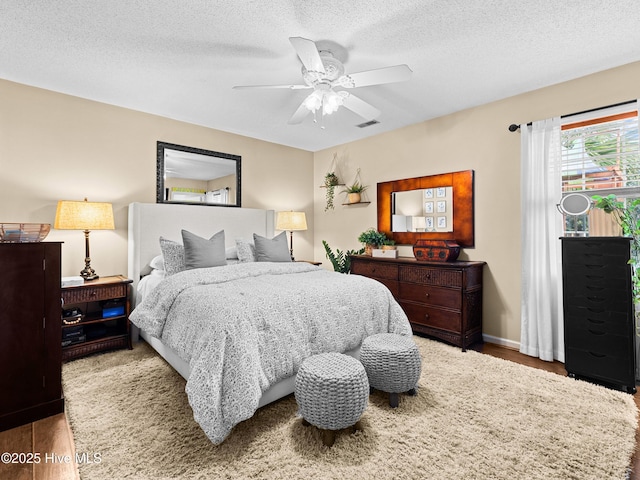 433 Dion Dr, Hubert, NC 28539 - bedroom featuring wood finished floors, a ceiling fan, a textured ceiling, and baseboards