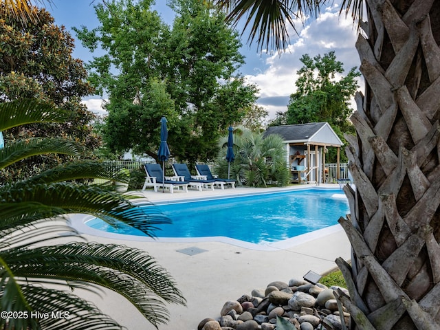 433 Dion Dr, Hubert, NC 28539 - pool with a patio, an exterior structure, fence, and an outbuilding