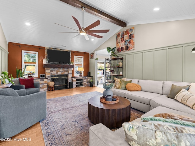 433 Dion Dr, Hubert, NC 28539 - living area featuring a ceiling fan, a fireplace, wood finished floors, lofted ceiling with beams, and a decorative wall