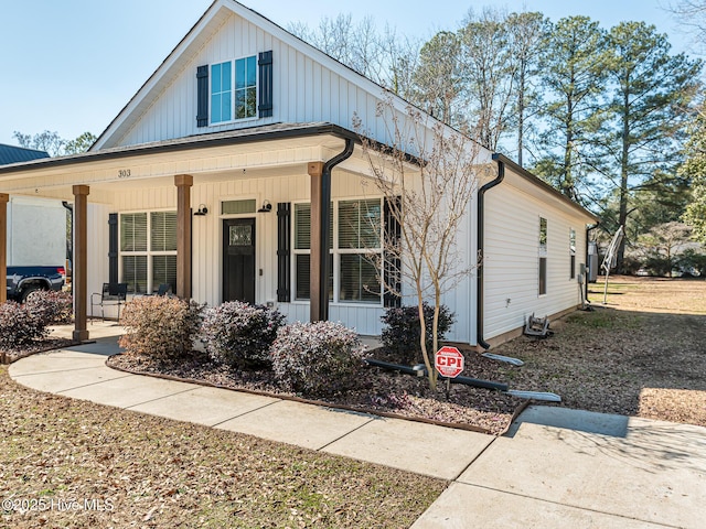 modern farmhouse featuring board and batten siding and a porch