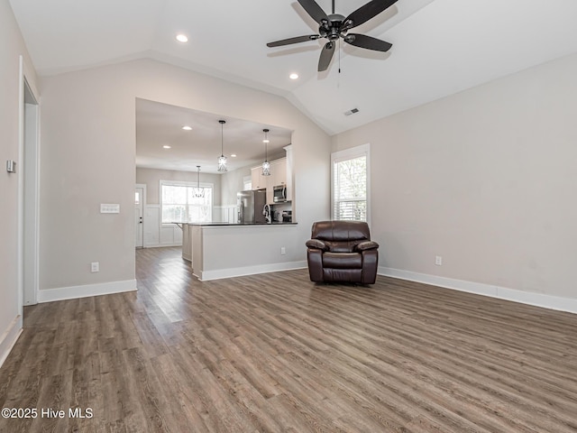 unfurnished living room featuring recessed lighting, vaulted ceiling, wood finished floors, and a ceiling fan