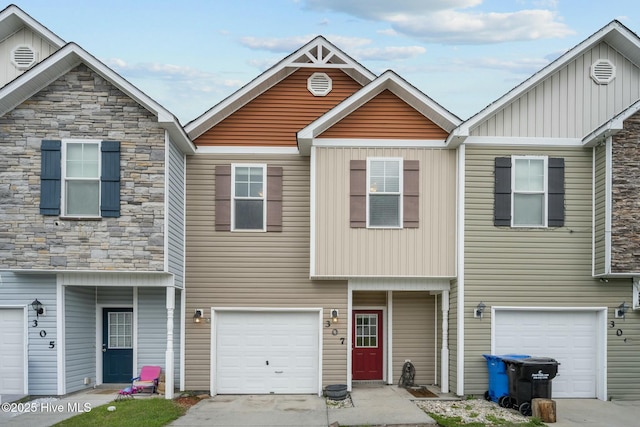 307 Cedar Island Trl, Holly Ridge, NC 28445 - multi unit property featuring board and batten siding, stone siding, and an attached garage
