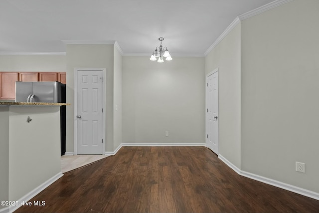 307 Cedar Island Trl, Holly Ridge, NC 28445 - unfurnished dining area featuring a chandelier, crown molding, wood finished floors, and baseboards