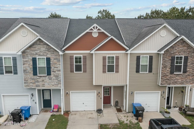 307 Cedar Island Trl, Holly Ridge, NC 28445 - view of property featuring concrete driveway, a shingled roof, and stone siding