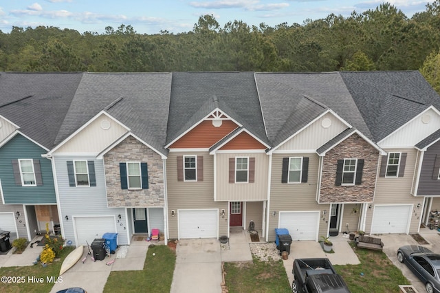 307 Cedar Island Trl, Holly Ridge, NC 28445 - townhome / multi-family property with an attached garage, roof with shingles, driveway, and stone siding