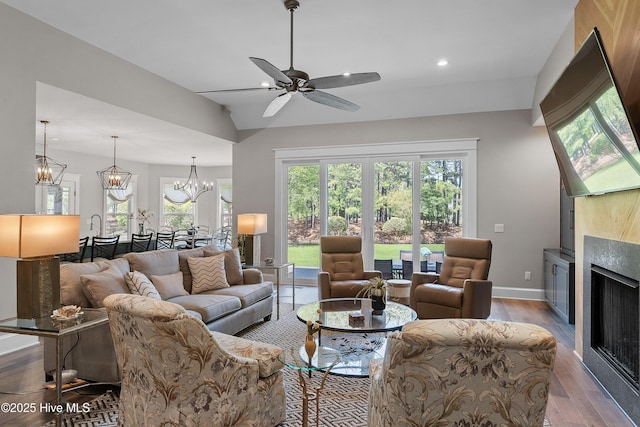 2592 St James Dr SE, Southport, NC 28461 - living room with wood finished floors, a fireplace, recessed lighting, a ceiling fan, and baseboards