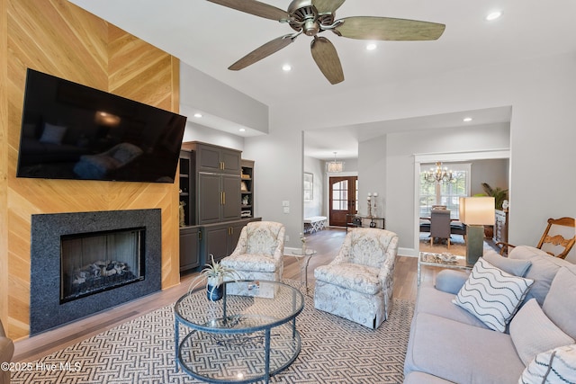 2592 St James Dr SE, Southport, NC 28461 - living area featuring wood finished floors, recessed lighting, a chandelier, ceiling fan, and a fireplace
