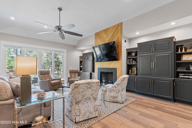 2592 St James Dr SE, Southport, NC 28461 - living area featuring vaulted ceiling, light wood-type flooring, a ceiling fan, recessed lighting, and a large fireplace