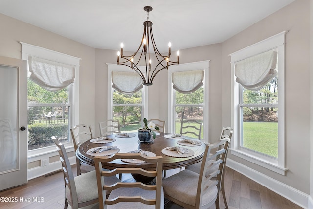 2592 St James Dr SE, Southport, NC 28461 - dining room with hardwood / wood-style flooring, a chandelier, and baseboards