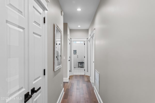 2592 St James Dr SE, Southport, NC 28461 - corridor with baseboards, dark wood-type flooring, and recessed lighting