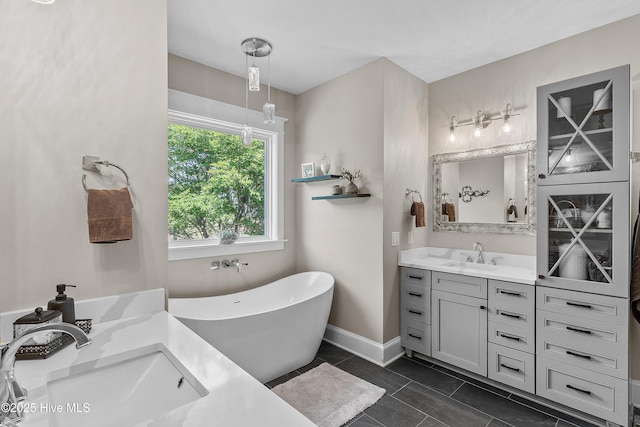 2592 St James Dr SE, Southport, NC 28461 - bathroom featuring vanity, a freestanding tub, and baseboards