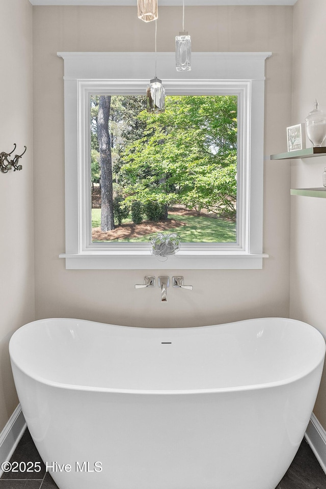 2592 St James Dr SE, Southport, NC 28461 - full bath featuring a soaking tub and baseboards