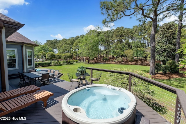 2592 St James Dr SE, Southport, NC 28461 - deck featuring outdoor dining space, an outdoor hot tub, a lawn, and view of wooded area