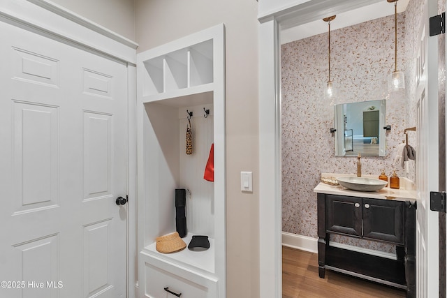 2592 St James Dr SE, Southport, NC 28461 - mudroom with a sink, wood finished floors, and baseboards