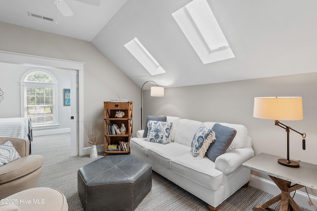 2592 St James Dr SE, Southport, NC 28461 - living area with a skylight, carpet floors, vaulted ceiling, and baseboards