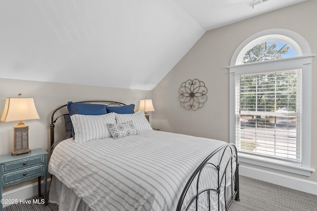 2592 St James Dr SE, Southport, NC 28461 - bedroom with lofted ceiling, carpet, and baseboards