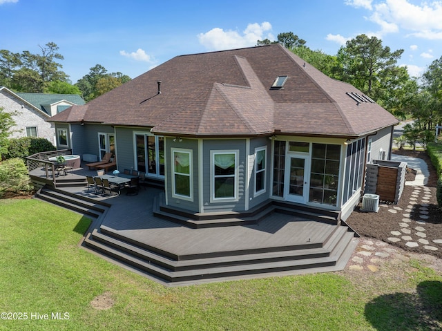2592 St James Dr SE, Southport, NC 28461 - rear view of property featuring a lawn, a deck, roof with shingles, outdoor lounge area, and a sunroom