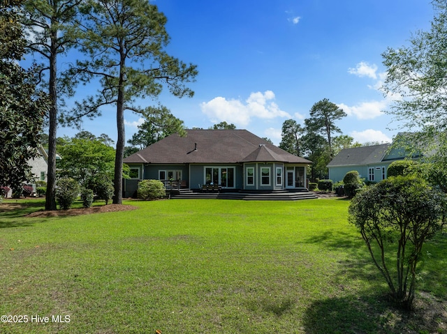 2592 St James Dr SE, Southport, NC 28461 - rear view of house featuring a lawn