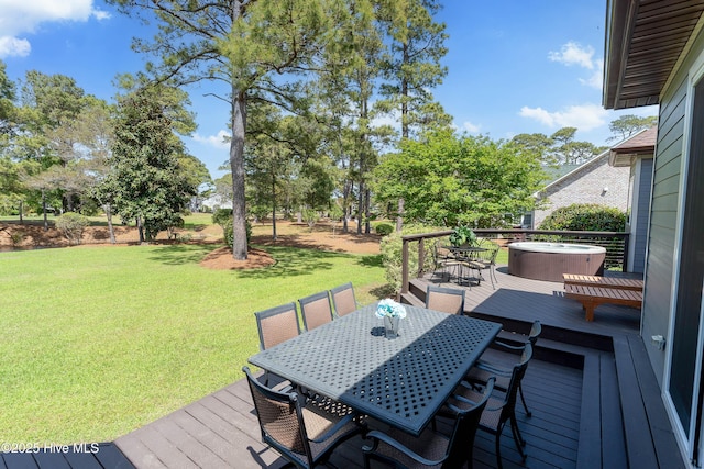 2592 St James Dr SE, Southport, NC 28461 - deck with outdoor dining space, a lawn, and a hot tub