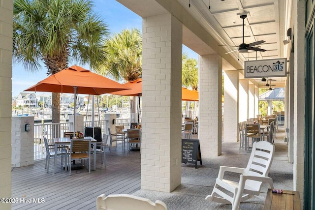 2592 St James Dr SE, Southport, NC 28461 - view of patio / terrace with outdoor dining space and ceiling fan