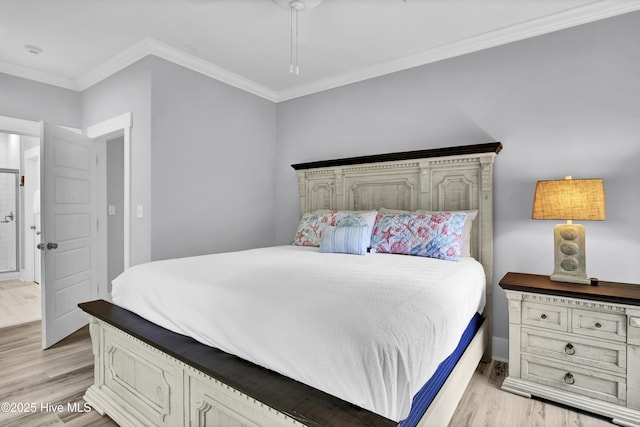 bedroom with light wood-type flooring, crown molding, and a ceiling fan