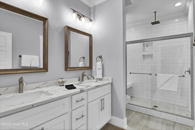 full bath with toilet, a stall shower, and a sink