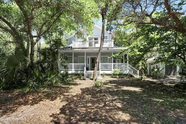 back of property featuring an outdoor structure and a porch