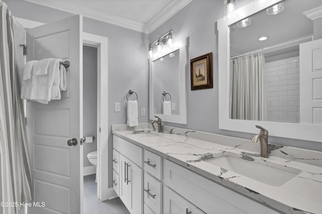 full bathroom featuring double vanity, toilet, ornamental molding, and a sink