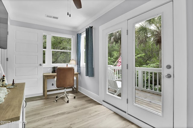 home office featuring light wood finished floors, visible vents, crown molding, baseboards, and ceiling fan