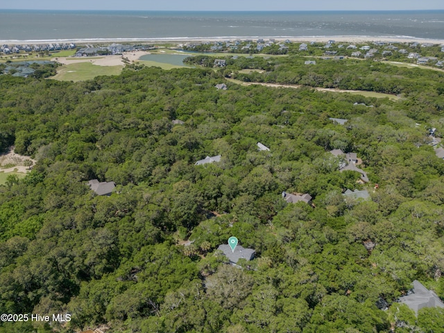 aerial view featuring a water view and a wooded view