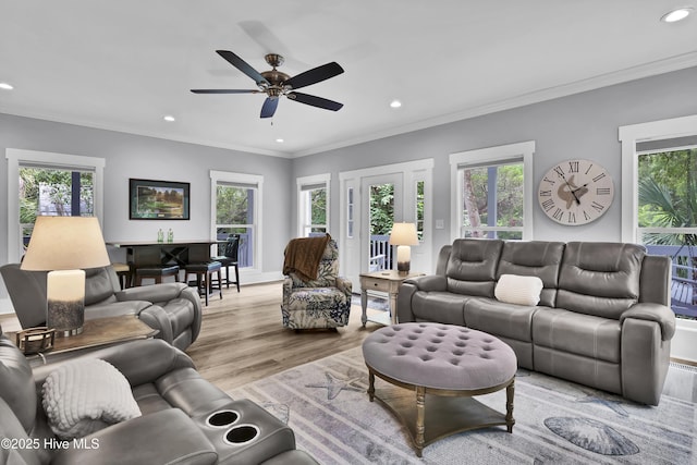 living room featuring plenty of natural light, recessed lighting, and light wood-style floors