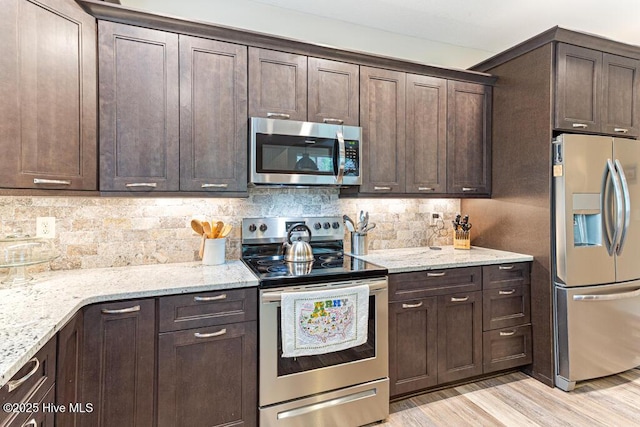 20 Barkley Ln, Pinehurst, NC 28374 - kitchen with dark brown cabinets, tasteful backsplash, light wood-type flooring, and stainless steel appliances