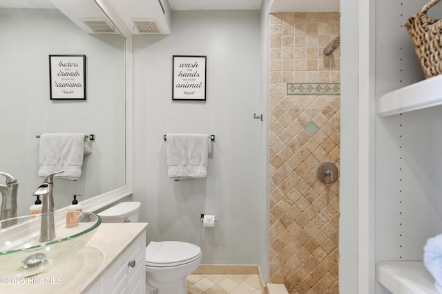 604 Lanvale Hills Cir, Leland, NC 28451 - bathroom featuring toilet, vanity, visible vents, and tiled shower