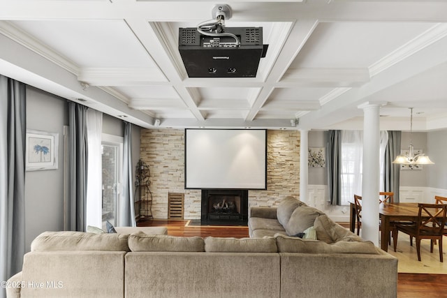 604 Lanvale Hills Cir, Leland, NC 28451 - home theater room with ornate columns, coffered ceiling, beam ceiling, dark wood-style flooring, and a notable chandelier