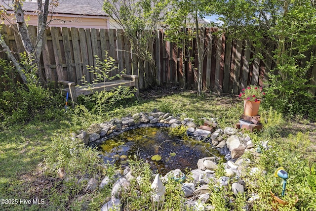 604 Lanvale Hills Cir, Leland, NC 28451 - view of yard with a garden pond and fence