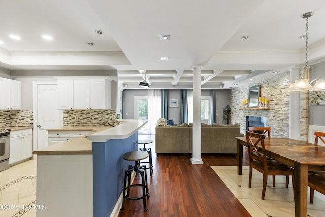 604 Lanvale Hills Cir, Leland, NC 28451 - kitchen with a kitchen breakfast bar, tasteful backsplash, electric stove, open floor plan, and ornamental molding