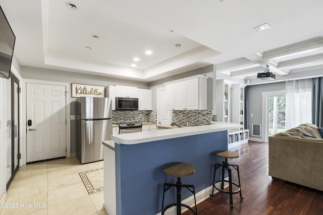 604 Lanvale Hills Cir, Leland, NC 28451 - kitchen with a kitchen breakfast bar, stainless steel appliances, light countertops, decorative backsplash, and a peninsula