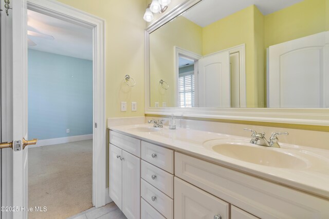 3675 W Medinah Ave, Southport, NC 28461 - bathroom featuring a sink, baseboards, and double vanity