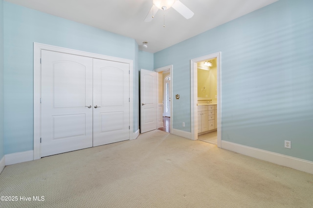 3675 W Medinah Ave, Southport, NC 28461 - unfurnished bedroom featuring light colored carpet, ensuite bath, a ceiling fan, baseboards, and a closet