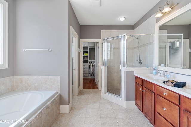 3675 W Medinah Ave, Southport, NC 28461 - full bath with a walk in closet, tile patterned flooring, vanity, a garden tub, and a stall shower