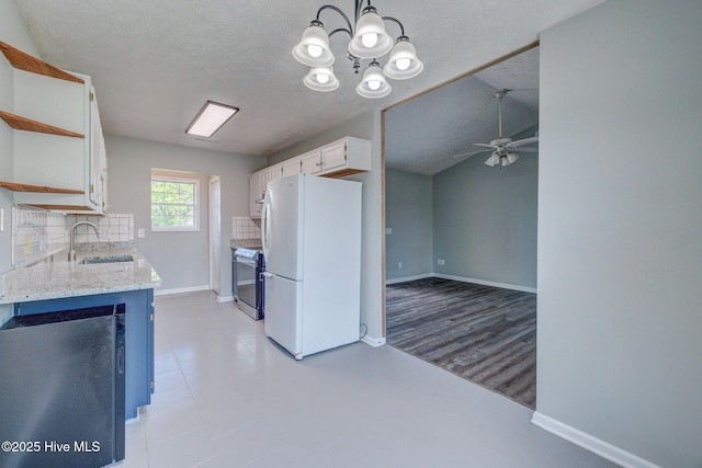 2715 Ashby Dr, Wilmington, NC 28411 - kitchen featuring a sink, stainless steel range with electric cooktop, baseboards, freestanding refrigerator, and white cabinetry