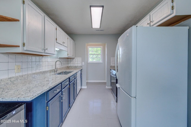 2715 Ashby Dr, Wilmington, NC 28411 - kitchen featuring a sink, stainless steel electric range, freestanding refrigerator, blue cabinetry, and open shelves