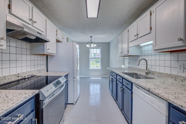 2715 Ashby Dr, Wilmington, NC 28411 - kitchen with under cabinet range hood, a sink, white dishwasher, electric range, and blue cabinetry