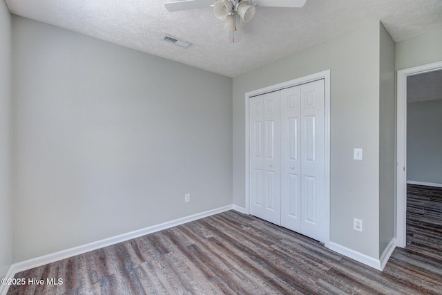 2715 Ashby Dr, Wilmington, NC 28411 - unfurnished bedroom with a textured ceiling, wood finished floors, a closet, baseboards, and visible vents