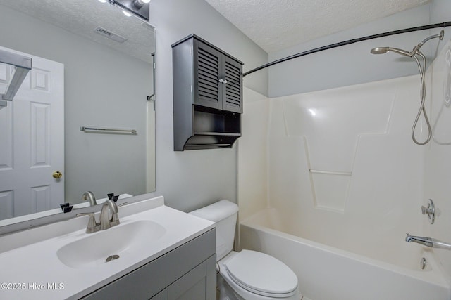 2715 Ashby Dr, Wilmington, NC 28411 - bathroom with a textured ceiling, vanity, toilet, shower / bathtub combination, and visible vents