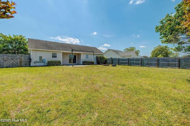 2715 Ashby Dr, Wilmington, NC 28411 - back of house with a patio area, a fenced backyard, and a yard