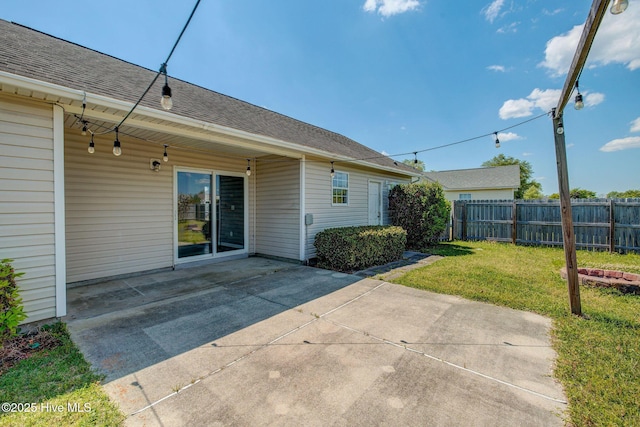 2715 Ashby Dr, Wilmington, NC 28411 - back of property featuring a yard, a patio area, roof with shingles, and fence